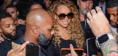 Mariah Carey chega ao Brasil e atende fãs na porta de hotel